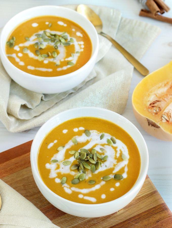 Close up bowl of autumn squash soup with bowl in background