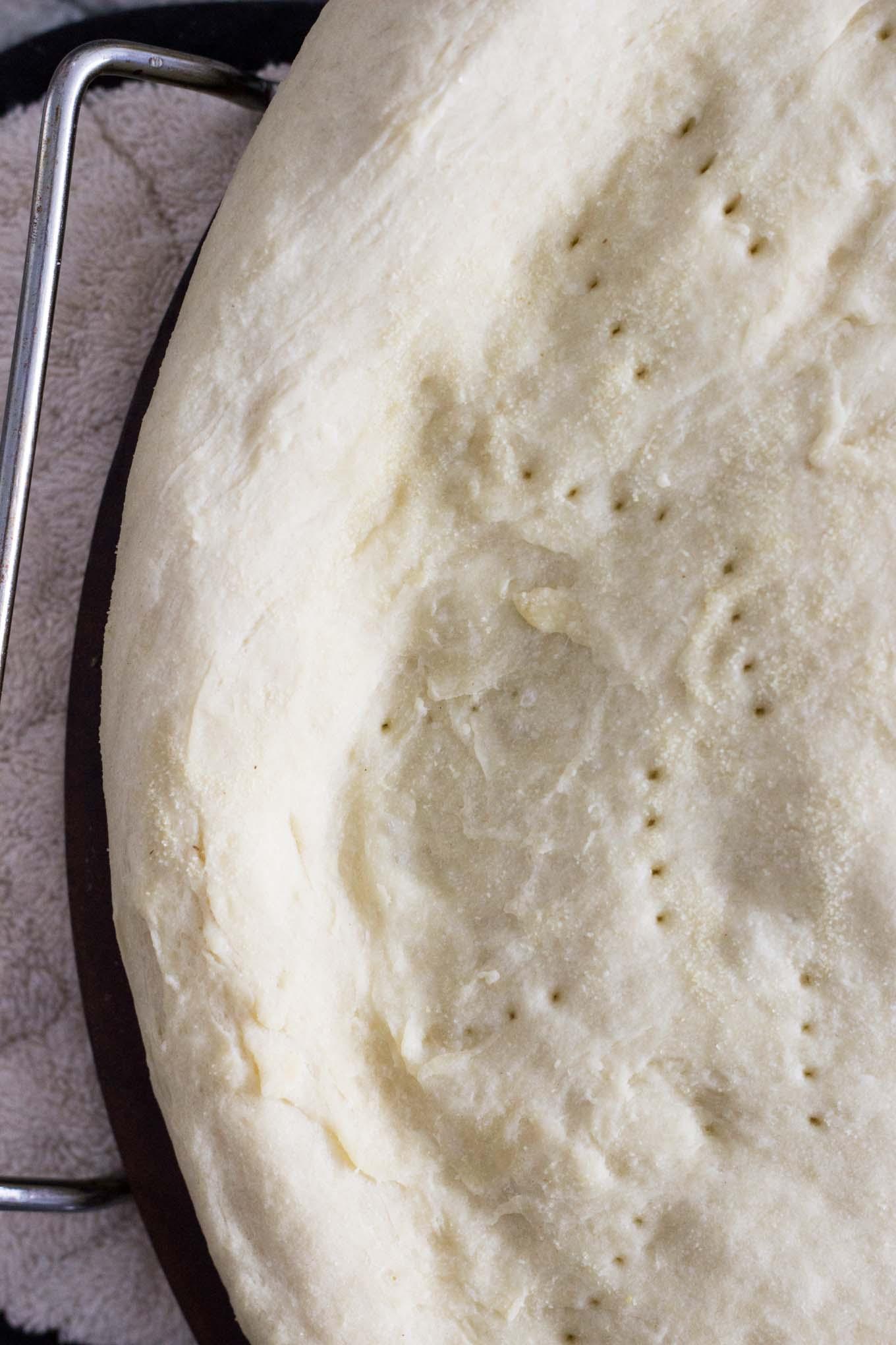 poke holes in pizza dough