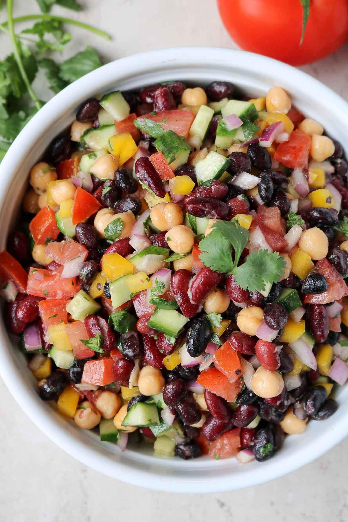 Three bean salad in a white bowl.