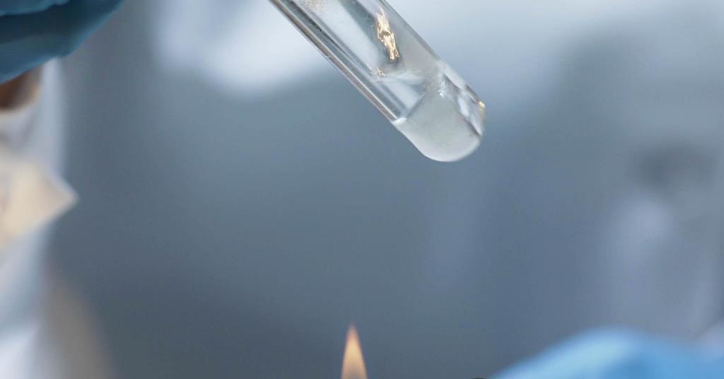 holding a test tube over a bunsen burner for heating