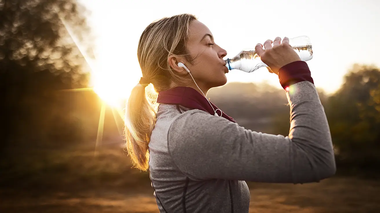 Person drinking a bottle of water outdoor