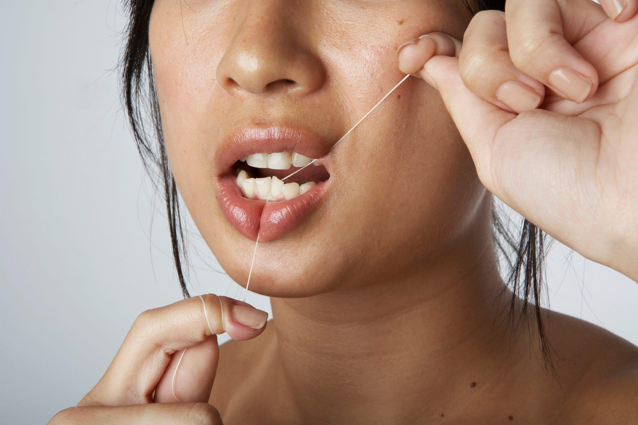 How To Floss Properly Using A String Floss, Pick, Or Water Flosser