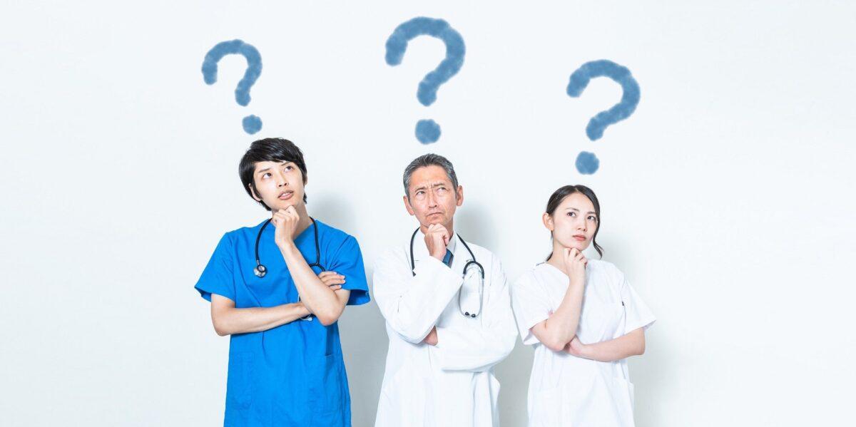 healthcare specialist looking up with question marks above them